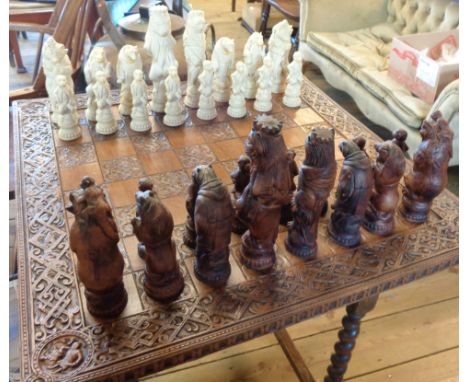 A large chess set and board with lion, bear, monkey and horse pieces