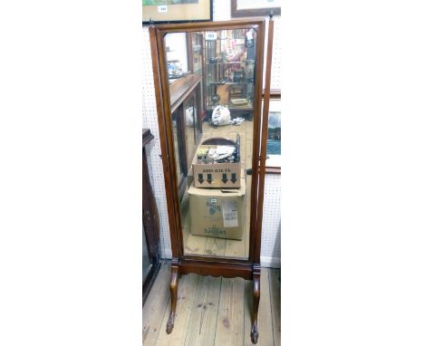 An early 20th Century walnut framed cheval mirror with flanking cast metal finials, set on splayed legs with stylised claw an