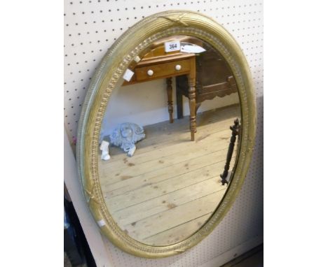 An old gilt framed bevelled oval wall mirror