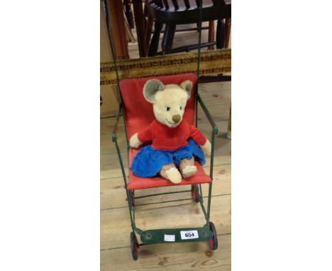 A vintage doll's pushchair and Teddy bear