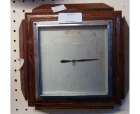 A 1930`s polished oak framed aneroid wall barometer with faded square dial