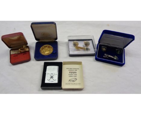 Two cufflink and tie pin sets, a pair of cufflinks, Zippo lighter for the Sultan of Oman's Navy, and a commemorative coin