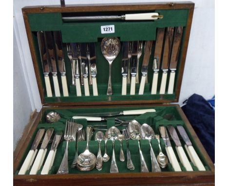 An oak canteen containing a vintage six place setting of silver plated cutlery, some with ivorine handles