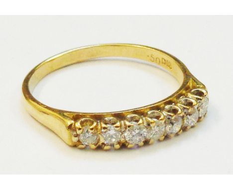 An import marked 750 gold seven stone diamond ring