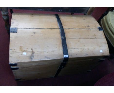 A 3' 2" 19th Century waxed pine and iron bound dome top travelling trunk with original latch and flanking heavy iron drop han