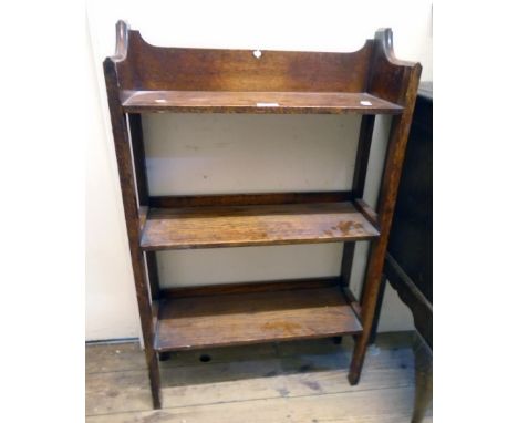 A 22" early 20th Century oak three shelf open bookcase with moulded top and slender square tapered supports