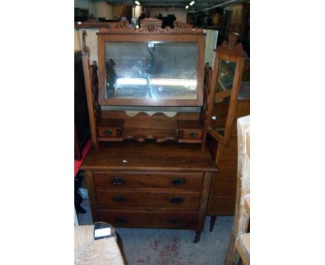 A 36" Edwardian walnut dressing chest with triple mirror, flanking pierced supports, trinket drawers and shelf over three lon