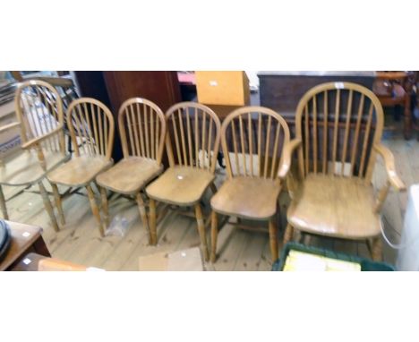 A set of four 20th Century hoop stick back kitchen chairs with moulded solid elm seats, set on ring turned supports - sold wi