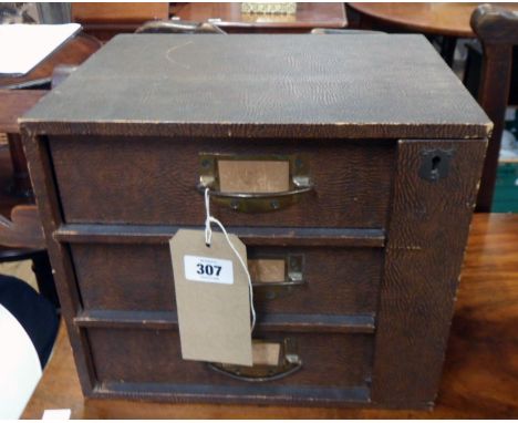 A 12 1/2" vintage bracket locking three drawer table-top file chest with textured paper finish