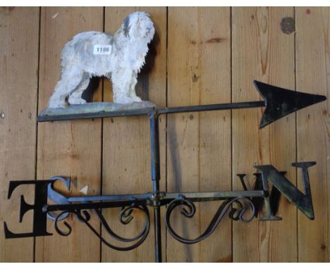A metal weather vane with sheepdog decoration