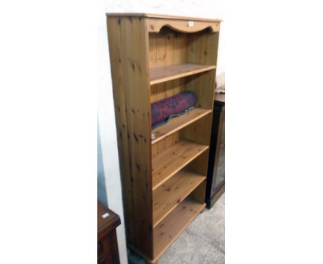 A 30" modern stained pine five shelf open bookcase, set on turned bun feet
