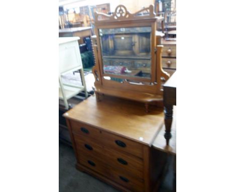 A 36" Edwardian satin walnut dressing chest with bevelled swing mirror, flanking pierced supports and shelf over three long g