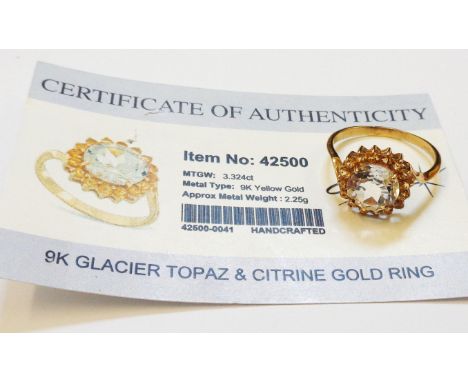 A marked 375 gold ring, set with central glacier topaz within a citrine border