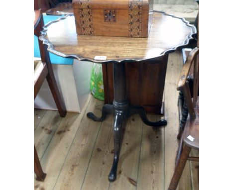 A 26 1/2" diameter 19th Century mahogany pie crust tilt-top pedestal table, set on turned pillar and tripod base with pad fee