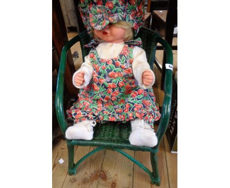 A vintage doll and chair