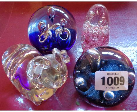 Four paperweights including a Caithness example