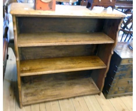 A 36" oak three shelf open bookcase with moulded top and shaped standard ends