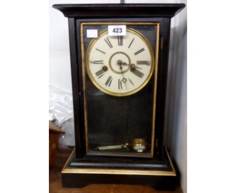 An early 20th Century ebonised and parcel gilt cased mantel clock with visible pendulum and American gong striking movement