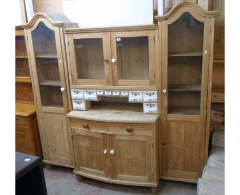 A 6' 10" Hungarian waxed pine four part dresser with glazed top and named ceramic spice drawers over a bow front base with tw