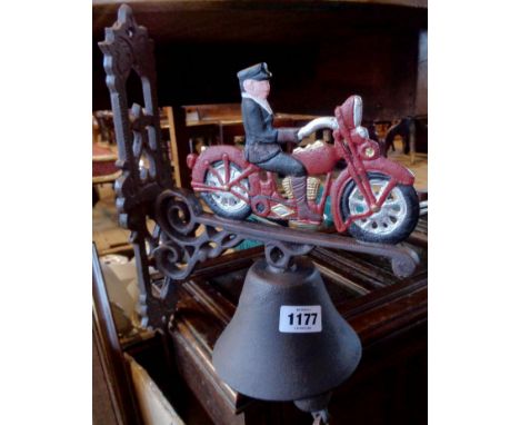 A modern painted reproduction cast iron porch bell with motorcycle pattern finial