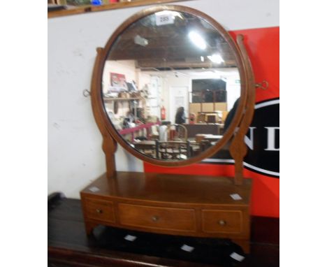A mahogany and strung framed platform dressing mirror with circular plate and three drawers to base, set on bracket feet