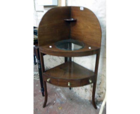 A 24" 19th Century mahogany corner washstand with small shelf and bowl aperture to the top, the undertier with central drawer