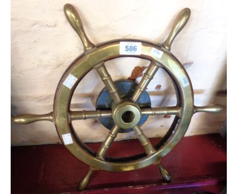A small vintage brass and teak six spoke ship's wheel