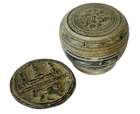 Two Southeast Asian pottery objects to include: A Thai Sawankhalok box with cover, c.15th century, 8 cm diameter; together wi