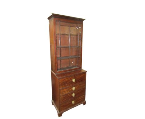 A small Georgian mahogany secretaire bookcase, the lower section enclosed by four drawer, the fall flap enclosing a fitted se