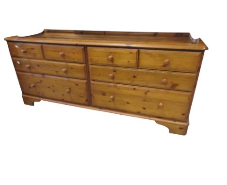 A Ducal pale pine bank of eight drawers, 72cm high x 170cm x 46cm, together with a matching three drawer bedside chest (2)