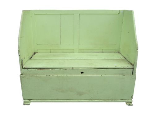 A rustic light green painted country made pine settle with box seat and panelled back raised on simple sledge supports 106 cm
