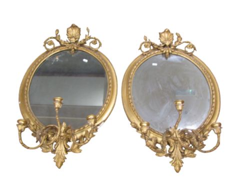 Pair of 19th century gilded oval girandole each fitted with three candle branches set beneath a shell and swag pediment, 90cm