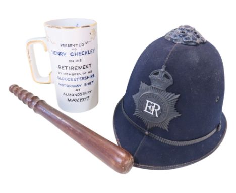 A Gloucestershire Constabulary Policeman's helmet, a truncheon and a Policeman’s Retirement presentation china tankard. (3)