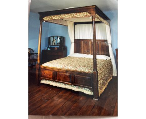 A traditional old English style panelled oak four poster bedstead and canopy with Jacobean style material, to accept a 5ft ma