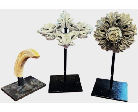 A Tudor Rose architecture boss, together with another Acanthus leaf boss both mounted on a metal stand, both approximately 30