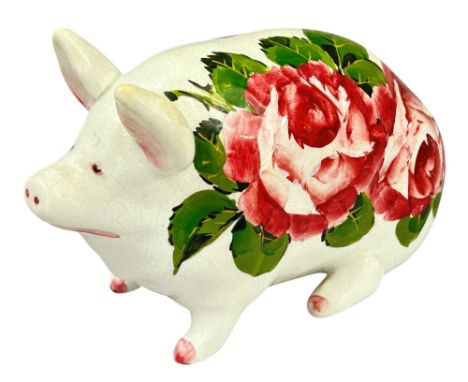 A Wemyss ware pig decorated by Joseph Nekola (JN) in cabbage roses pattern, pink highlights to ears, feet and tail, painted m