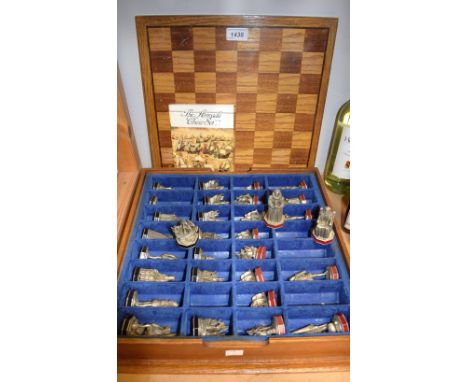 A Danbury Mint Armada pewter chess set, push-on checkered playing board cover