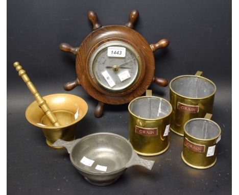 A pewter quaiche; a brass mortar and pestle; a set three graduated brass grain measures with copper labels; an oak ship's whe