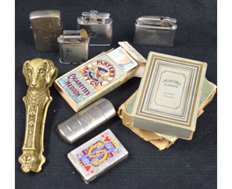 A novelty brass nutcracker, moulded with hound's heads; a Ronson pocket lighter; other engine turned cigarette lighters; nave
