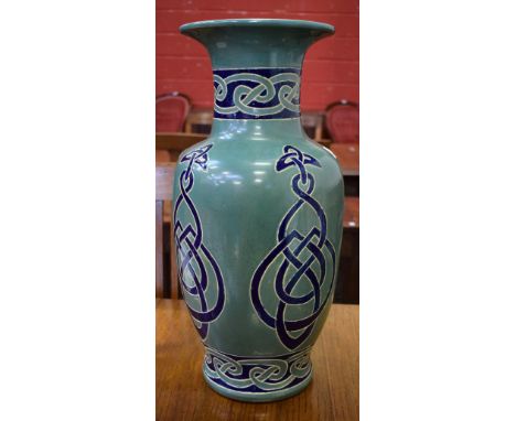 A large baluster vase, celtic pattern on a jade green ground