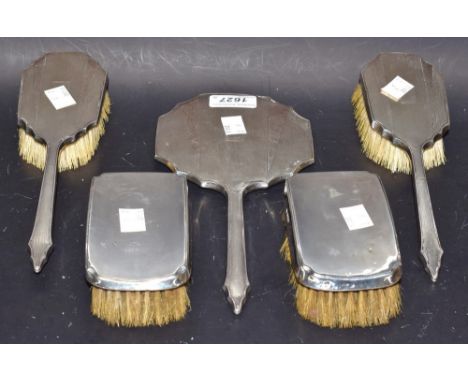 An Art Deco silver hairbrush, another, and a mirror, hallmarked; a pair of canted rectangular silver clothes brushes, hallmar