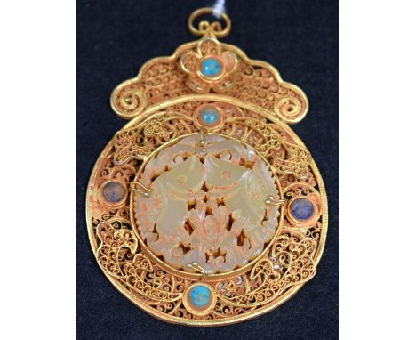 A gilt metal and jade pendant, unmarked