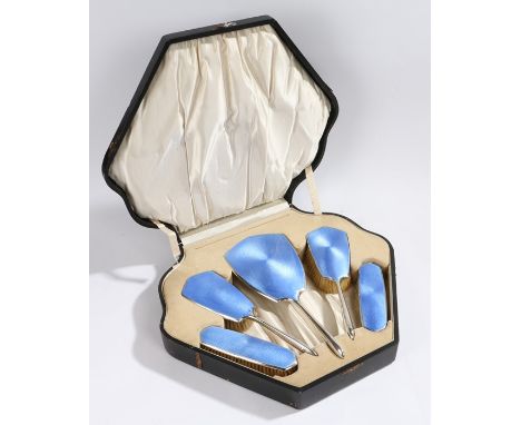 George V cased silver and guilloche enamel vanity set, Birmingham 1926,  with a mirror and four brushes with blue enamel back