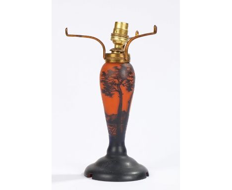 Art Nouveau lamp in the style of Galle, the orange body with overlaid black landscape decoration, 26.5cm high