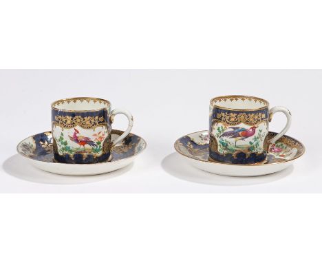 Pair of 19th century porcelain coffee cans and saucers, the blue scale grounds with cartouches of floral sprays and exotic bi