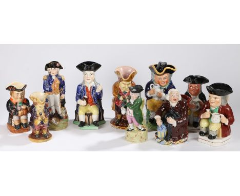 Collection of Staffordshire Toby Jugs, with seated examples in various colours, a standing Nelson example, a Squire seated ex
