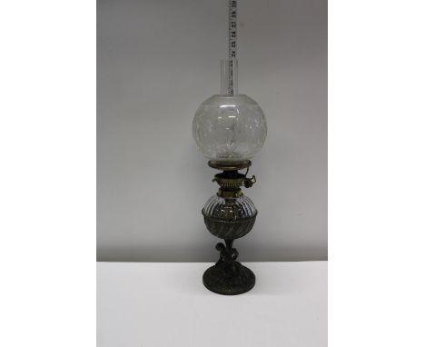An antique glass and brass oil lamp with a Hinks duplex burner 