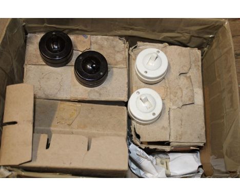 A box of antique porcelain light switches 