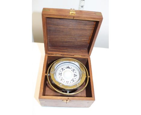 A boxed brass gimbal compass 