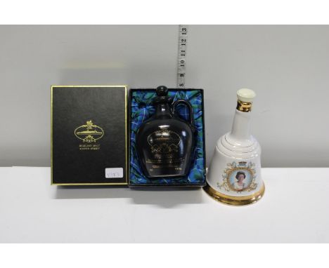 Two empty ceramic whiskey decanters 